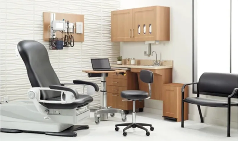 Physician office exam room with exam chair and cabinetry